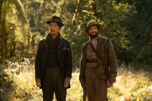 FIRST COW - Orion Lee (left) as "King-Lu" and John Magaro (right) as "Cookie"