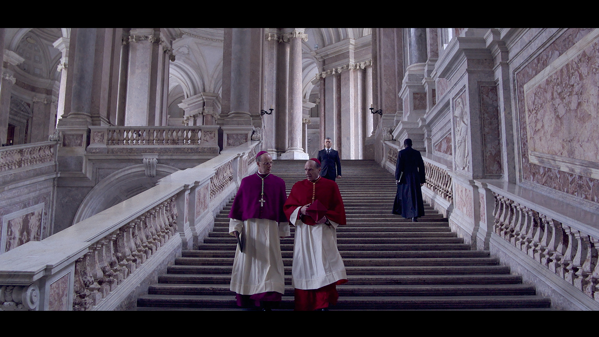 (L to R) Brían F. O'Byrne as Cardinal O'Malley and Ralph Fiennes as Cardinal Lawrence in director Edward Berger's CONCLAVE, a Focus Features release. Credit: Courtesy of Focus Features. © 2024 All Rights Reserved.