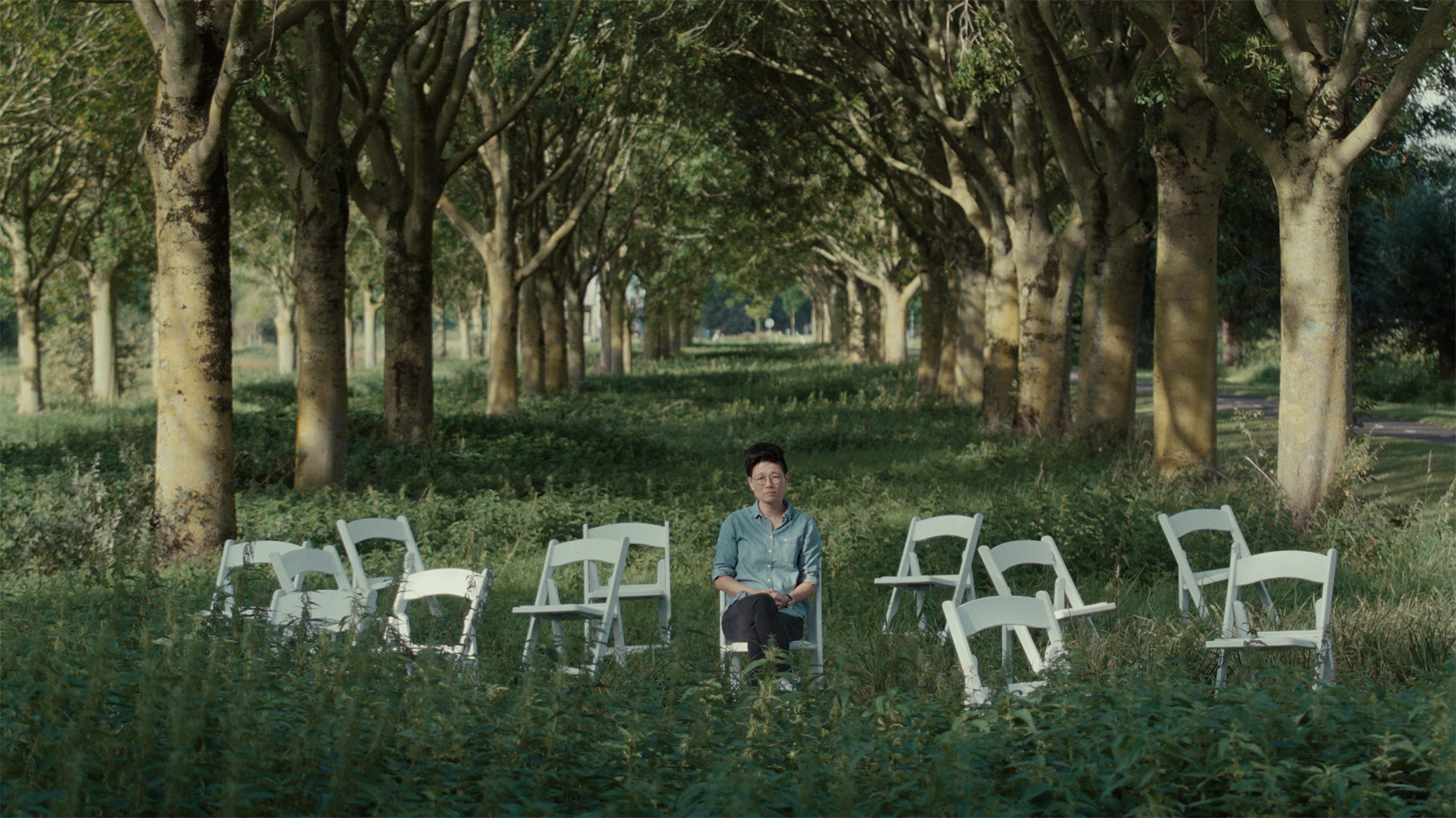 BETWEEN_GOODBYES_KeyStill_M_with_empty_chairs_PRIMARY STILL