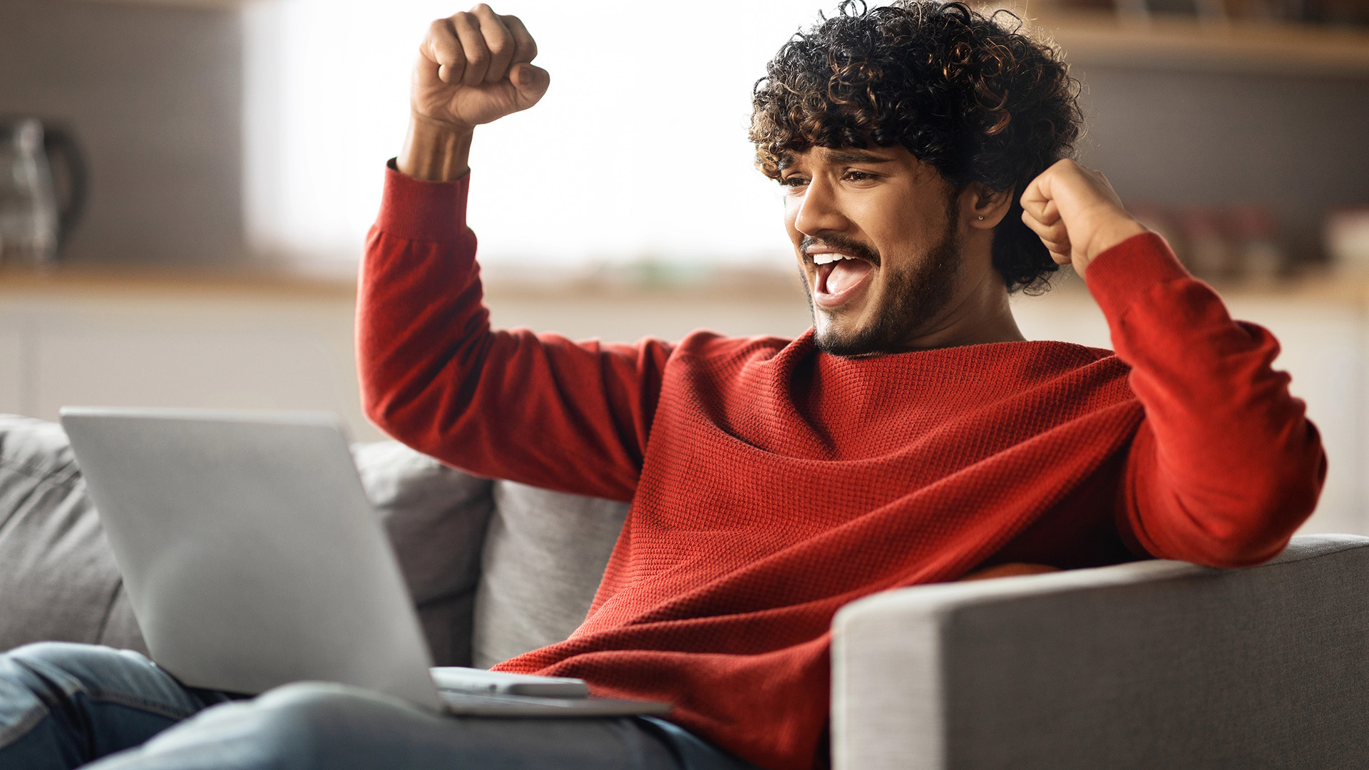 Great News. Portrait Of Happy Excited Indian Man Celebrating Success With Laptop At Home, Overjoyed Young Eastern Guy Looking At Computer Screen, Raising Fists And Exclaining With Joy, Closeup
